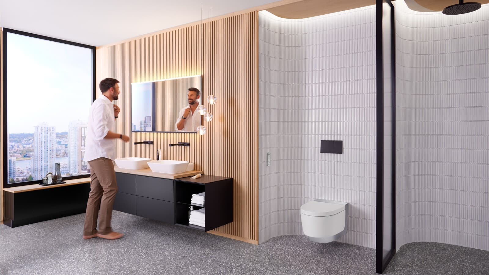 Mann in Badezimmer vor Spiegel Geberit Option Plus und schwarzen Geberit ONE Badmöbeln (© Geberit) Mann in Badezimmer vor Spiegel Geberit Option Plus und schwarzen Geberit ONE Badmöbeln (© Geberit)
