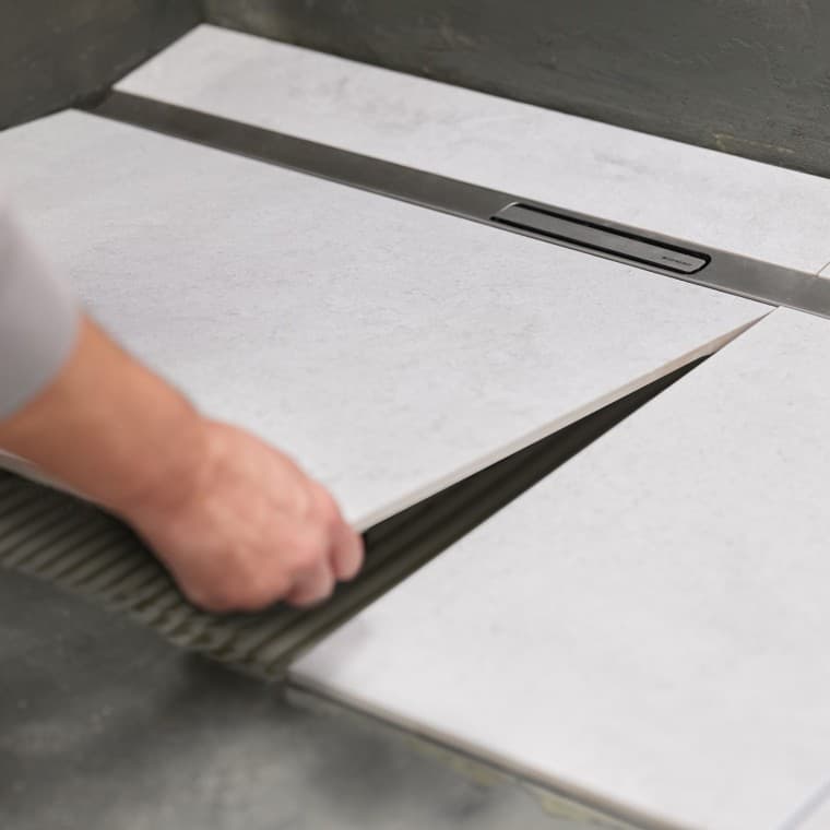 Le système d'ancrage des écoulements de douche garantit une fixation sûre au sol. Le système d'ancrage des écoulements de douche garantit une fixation sûre au sol.